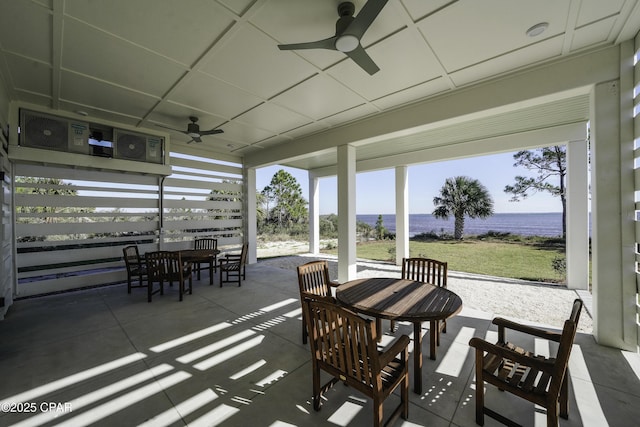 view of patio / terrace featuring ceiling fan and a water view