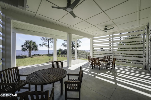 view of patio featuring ceiling fan and a water view