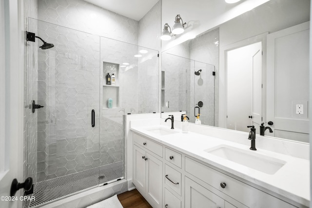 bathroom with vanity, wood-type flooring, and a shower with door