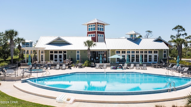 view of swimming pool featuring french doors and a patio area