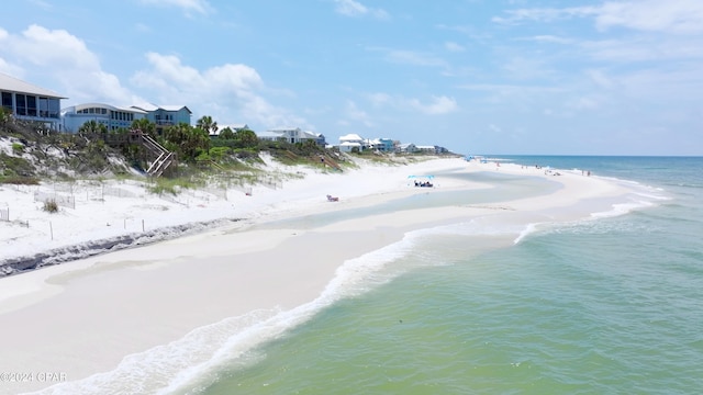 drone / aerial view with a water view and a beach view