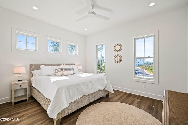 bedroom with ceiling fan, dark hardwood / wood-style floors, and multiple windows