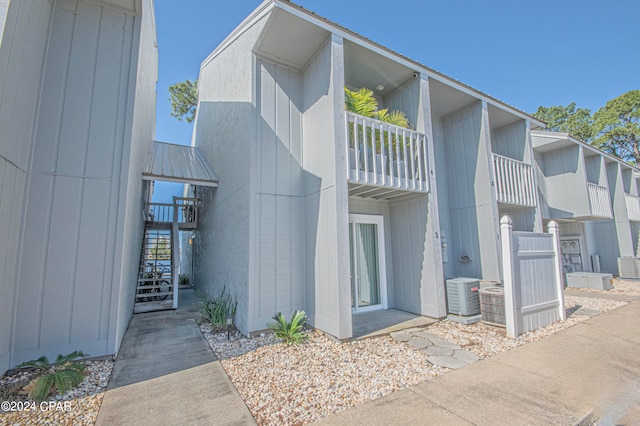 view of front of home with a balcony and central AC unit