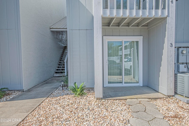 property entrance featuring central AC unit and a balcony