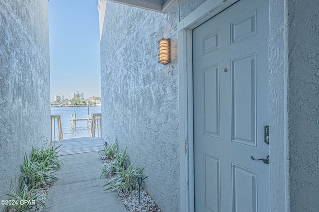 view of exterior entry featuring a water view