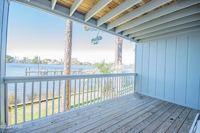 wooden terrace featuring a water view