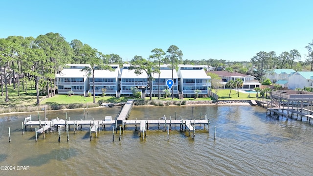 view of dock featuring a water view and a yard