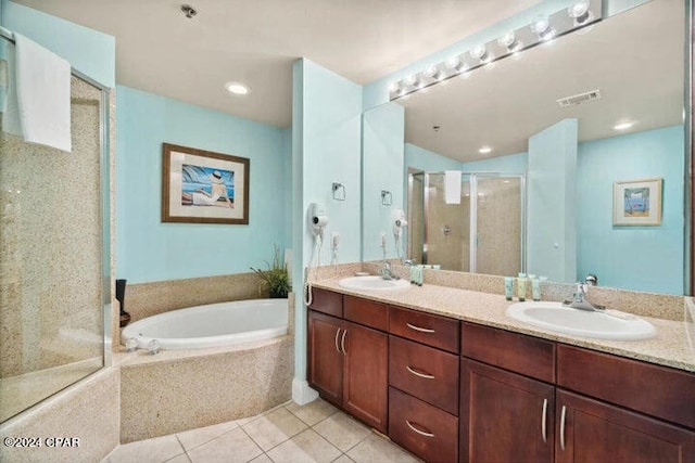 bathroom featuring dual sinks, shower with separate bathtub, tile floors, and large vanity