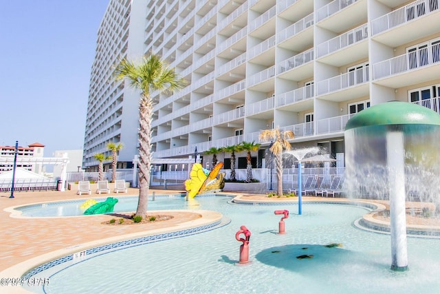 view of swimming pool with pool water feature