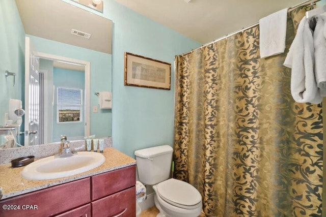 bathroom featuring oversized vanity and toilet