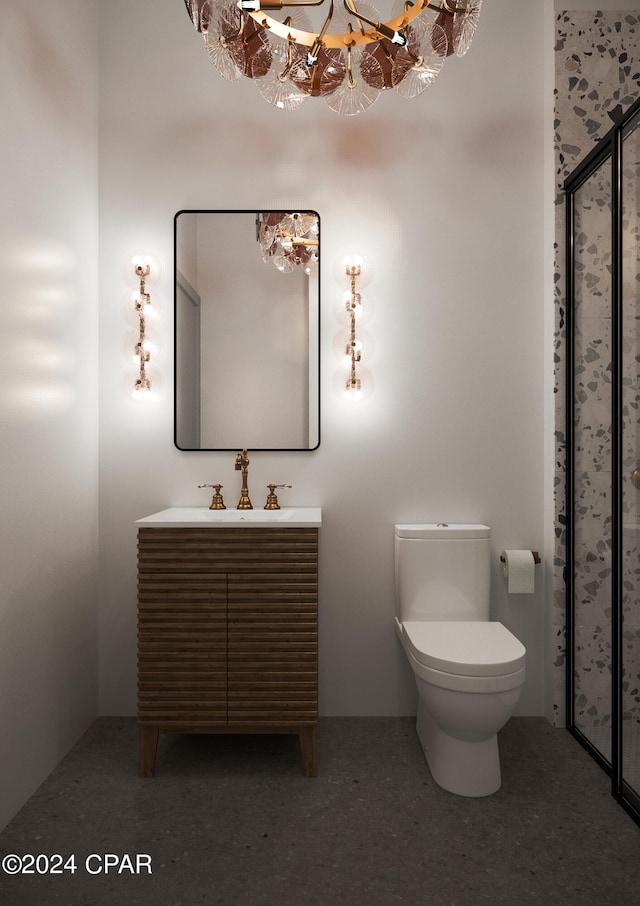 bathroom featuring a notable chandelier, vanity, and toilet