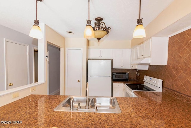 kitchen featuring tasteful backsplash, hanging light fixtures, white cabinetry, a sink, and white appliances