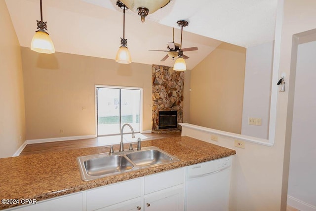 kitchen featuring a fireplace, open floor plan, white cabinetry, a sink, and dishwasher