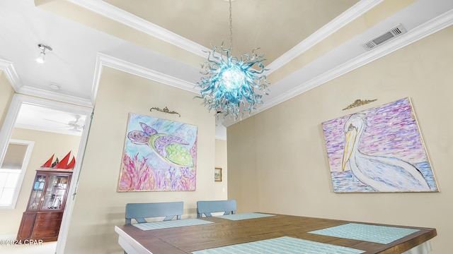 dining area with crown molding and ceiling fan with notable chandelier