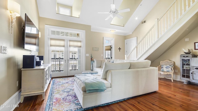 living room with ceiling fan, dark wood-type flooring, high vaulted ceiling, and french doors