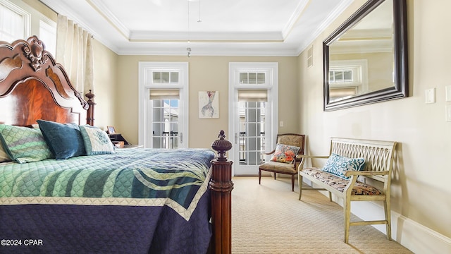 carpeted bedroom featuring a raised ceiling and crown molding