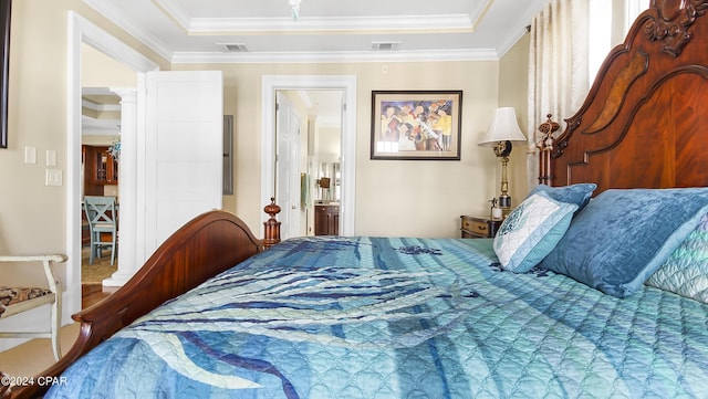 bedroom featuring a tray ceiling and ornamental molding