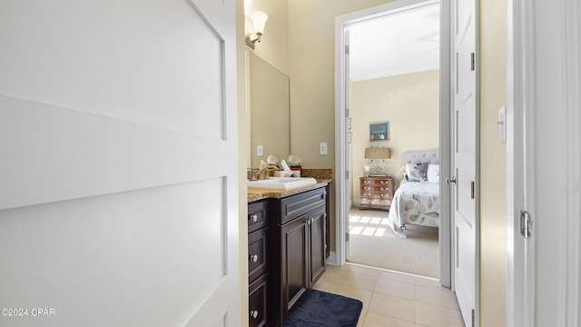 bathroom featuring tile patterned flooring, vanity, and ornamental molding