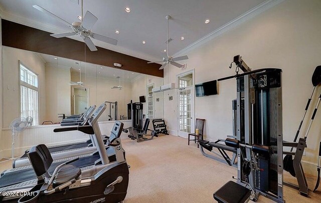 workout area with ceiling fan, a wall unit AC, crown molding, a towering ceiling, and light carpet