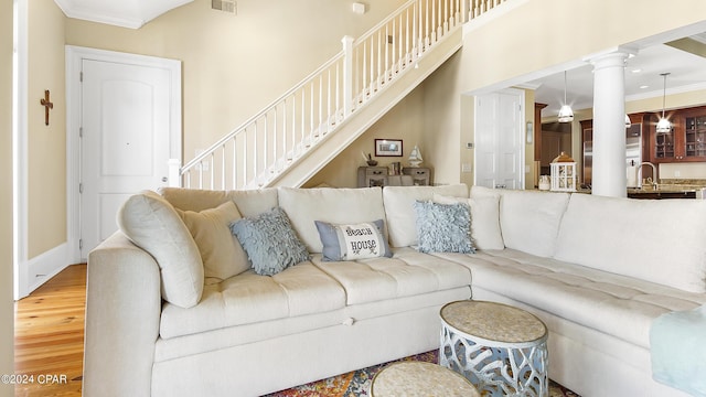 living room with wood-type flooring and crown molding