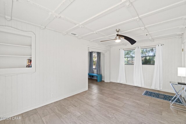 unfurnished living room featuring ceiling fan and light wood-type flooring