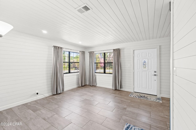 entryway with tile floors and wood ceiling