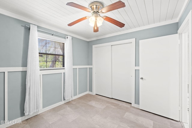 unfurnished bedroom with a closet, ceiling fan, light tile floors, and wooden ceiling