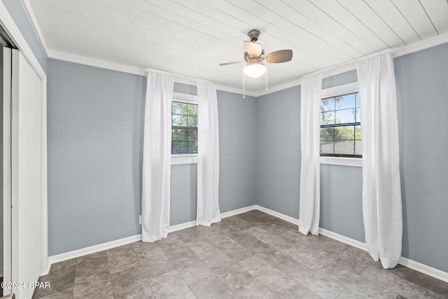 tiled spare room with plenty of natural light and ceiling fan