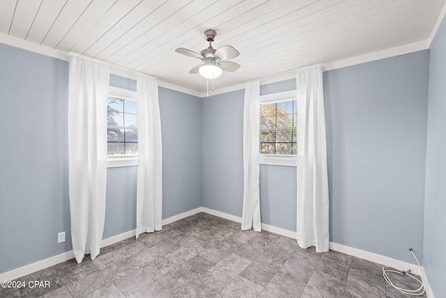 spare room featuring a healthy amount of sunlight, tile floors, ceiling fan, and wooden ceiling