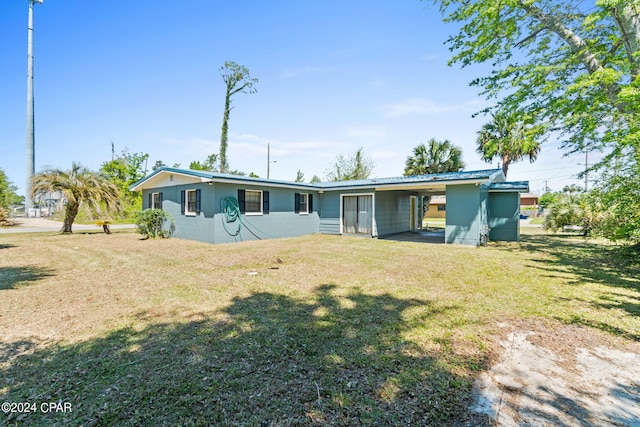 rear view of property featuring a lawn