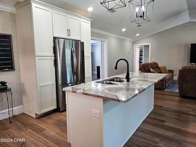 kitchen featuring dark wood-type flooring, stainless steel fridge, decorative light fixtures, ornamental molding, and white cabinets