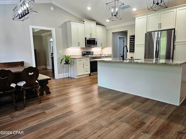 kitchen with appliances with stainless steel finishes, dark wood-type flooring, white cabinetry, and decorative light fixtures