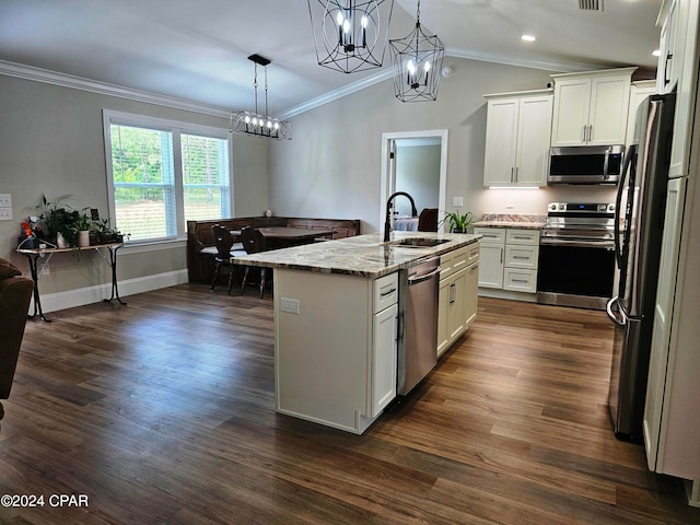 kitchen with dark wood-type flooring, white cabinets, pendant lighting, stainless steel appliances, and light stone countertops