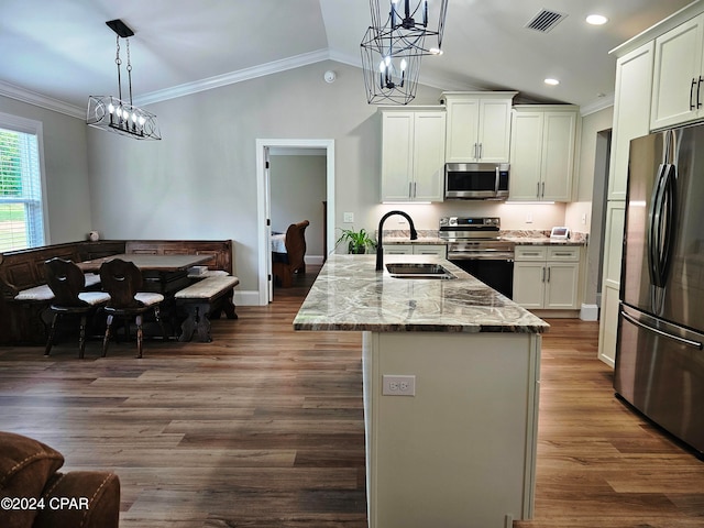 kitchen featuring light stone counters, hanging light fixtures, white cabinets, stainless steel appliances, and dark wood-type flooring