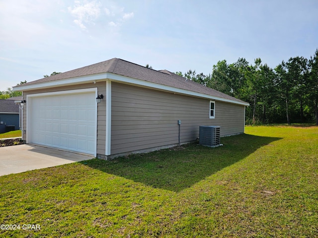 view of side of home featuring central AC, a garage, and a lawn