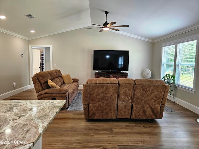 living room featuring dark hardwood / wood-style flooring, ceiling fan, ornamental molding, and vaulted ceiling