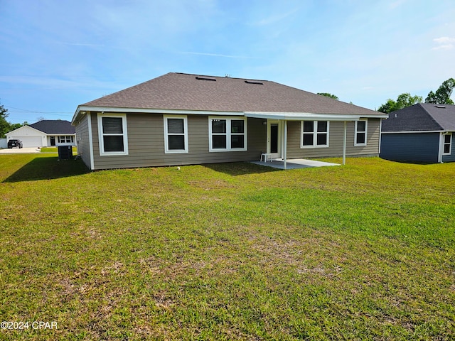 back of property featuring a lawn and a patio