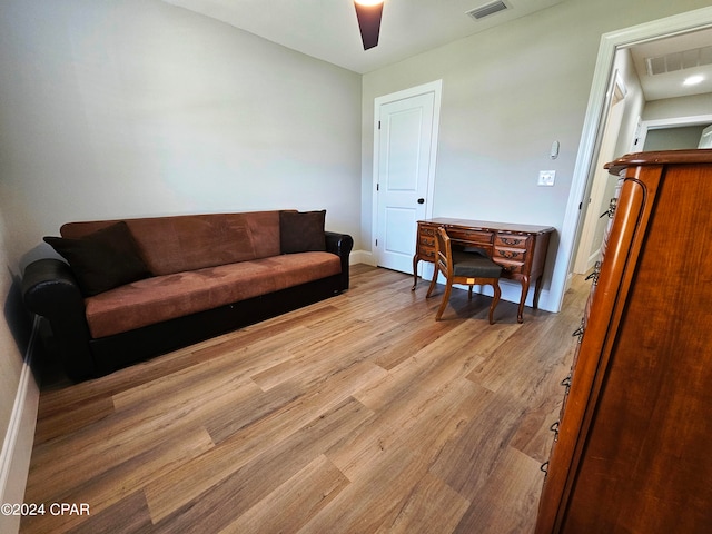 living room featuring ceiling fan and light hardwood / wood-style flooring