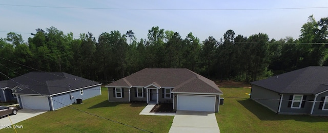 view of front of home featuring a front yard, central air condition unit, and a garage