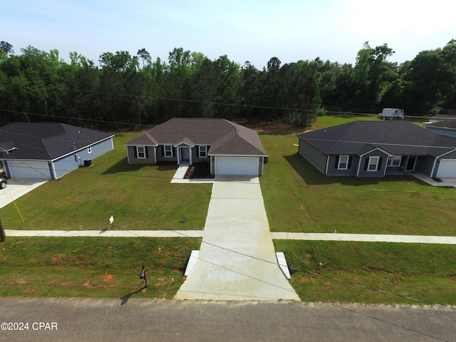 view of front of house with a front yard and a garage