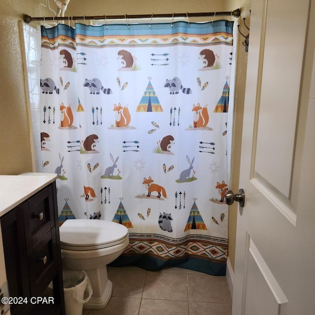 bathroom with toilet, tile floors, and vanity