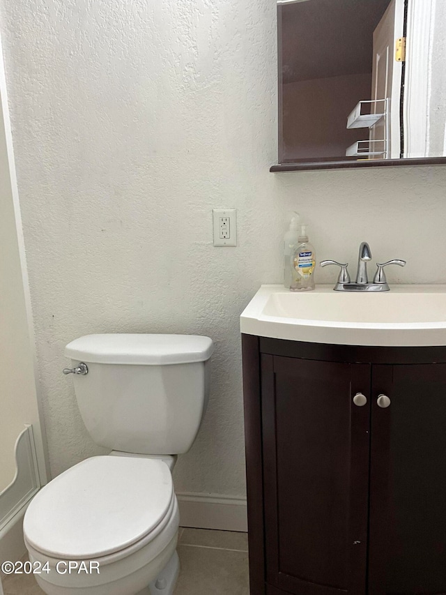 bathroom featuring toilet and vanity