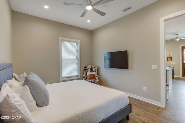 bedroom with hardwood / wood-style flooring and ceiling fan