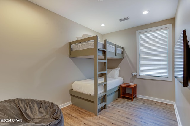 bedroom featuring light hardwood / wood-style flooring and multiple windows