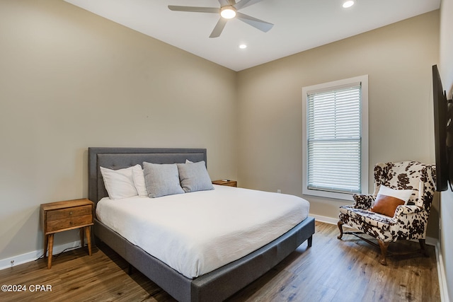 bedroom with dark hardwood / wood-style flooring and ceiling fan