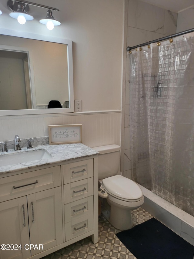 bathroom featuring toilet, vanity, and tile flooring