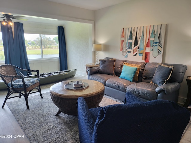 living room featuring ceiling fan and light wood-type flooring