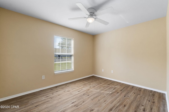 spare room with ceiling fan and light wood-type flooring