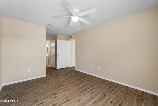 unfurnished room featuring ceiling fan and dark wood-type flooring