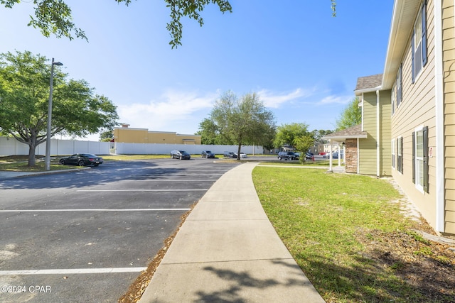 view of parking / parking lot with a yard